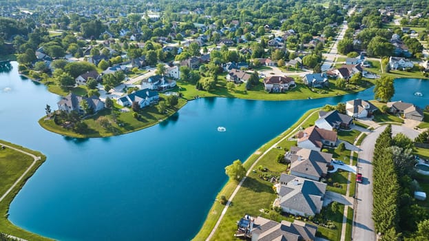 Image of Large pond with rich expensive homes in neighborhood aerial