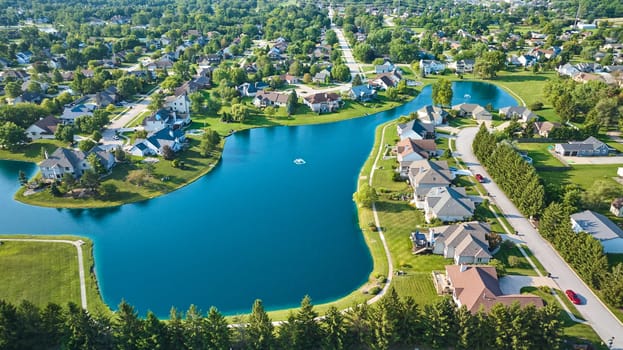 Image of Wide view of expensive neighborhood with large pond and two water fountains