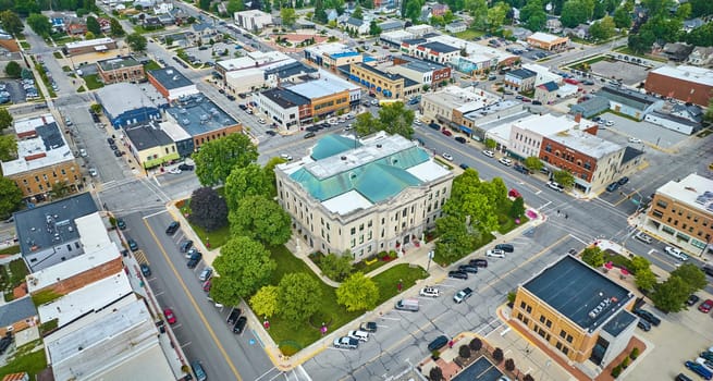Image of Aerial wide shot of Auburn Indiana city with focus on downtown courthouse