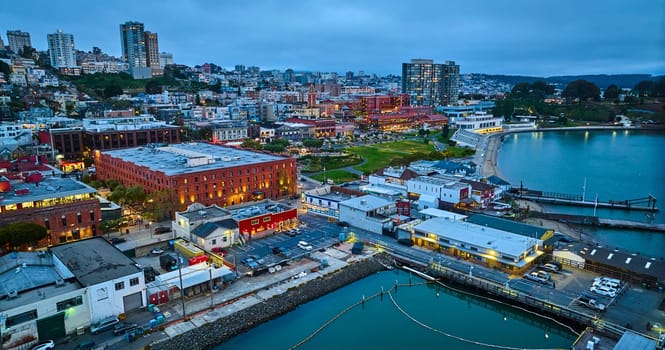 Image of Dusk aerial Fishermans Wharf coastal area with city lights at night