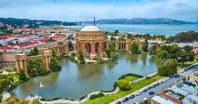 Image of Pond around open rotunda and colonnade of Palace of Fine Arts with Golden Gate Bridge aerial