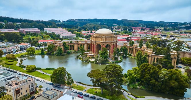 Image of Aerial pond around open rotunda and colonnade of Palace of Fine Arts with Roman ruins vibe