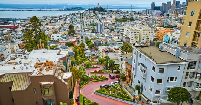 Image of Aerial Lombard Street curving red brick road with cars and view of downtown San Francisco