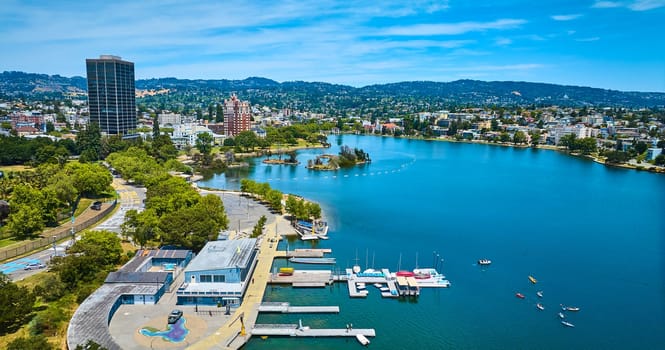 Image of Aerial boating center on Lake Merritt with Pelican Island in distance with buildings along shore