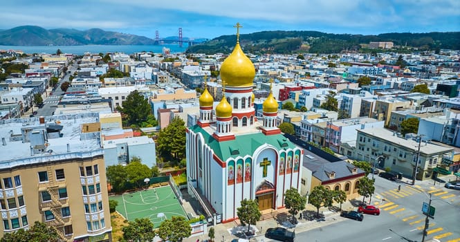 Image of Aerial Holy Virgin Cathedral with Golden Gate Bridge in background