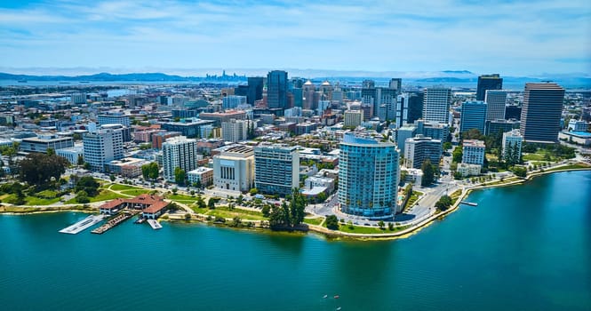 Image of Wide aerial over Lake Merritt with downtown Oakland CA and distant San Francisco with bay