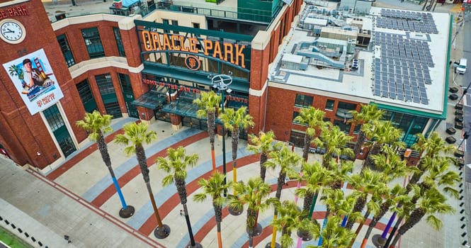 Image of Oracle Park Willie Mays Gate entrance downward aerial over palm trees