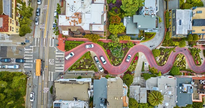 Image of Straight down view Lombard Street top of hill with cars driving down red brick road aerial