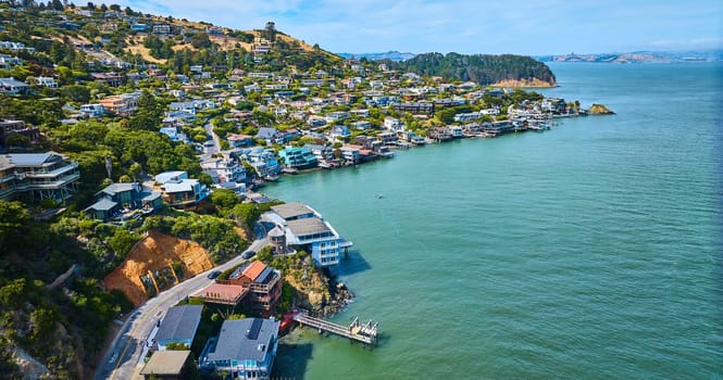Image of Lyford Cove with aerial Tiburon city with houses against shoreline and up hilly cliff