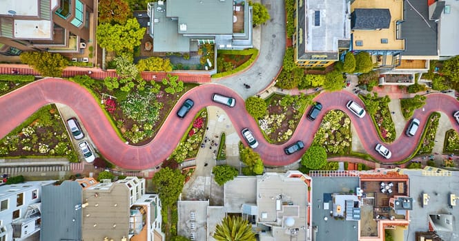 Image of Straight down aerial over Lombard Street with cars and road running horizontally through shot