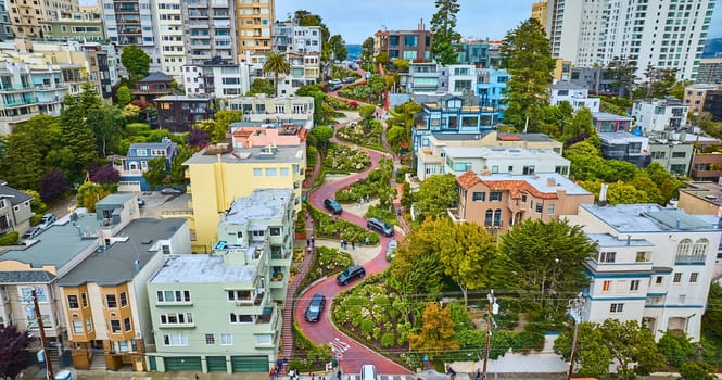 Image of Low aerial red brick road on iconic Lombard Street with houses looking up hill