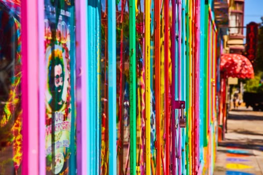 Image of Pride rainbow gate with padlock side view along street