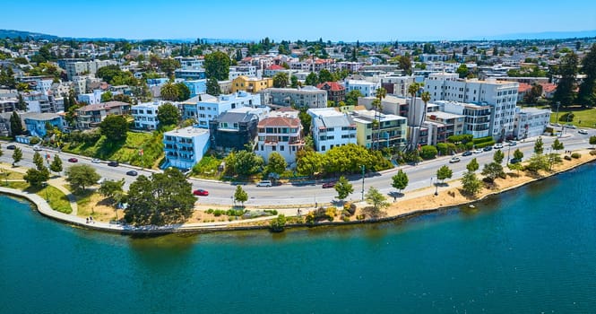 Image of Oakland aerial of residential area with road along lakeshore and blue sky