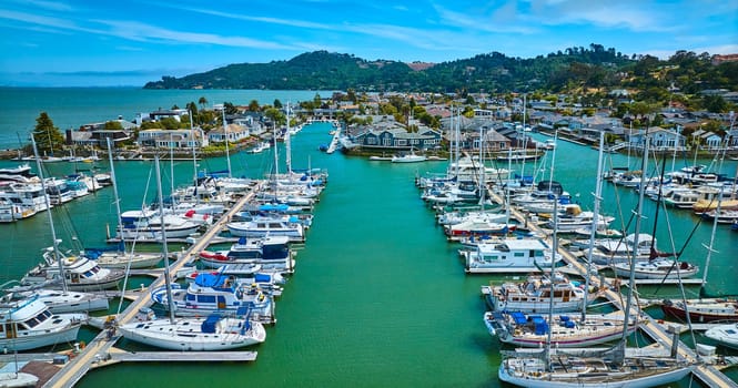 Image of Aerial Paradise Cay Yacht Harbor boats on teal water with waterfront properties behind