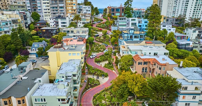 Image of Gorgeous wider aerial of iconic Lombard Street with buildings on either side of red brick road