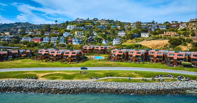 Image of Shoreline Park Tiburon aerial with people along coastline with houses on hillside