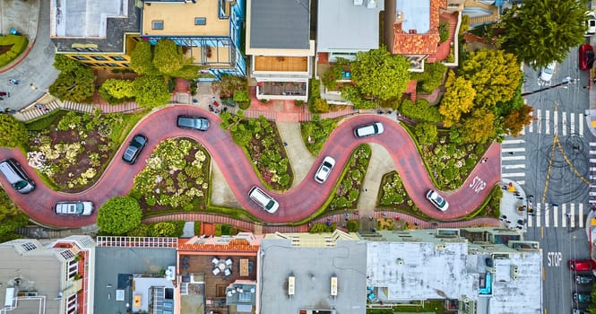 Image of Straight down shot over Lombard Street with cars and road running horizontally through aerial