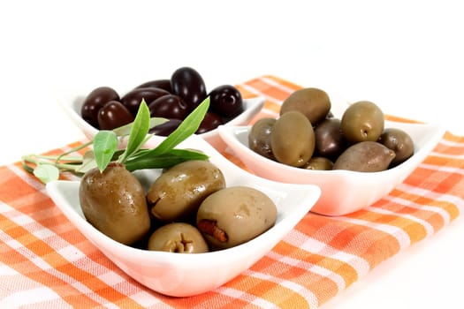different varieties of olives with olive branch