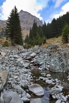 a small river flowing over a mountain valley