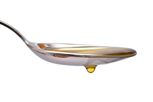 Olive oil dripping from a spoon over a white background.