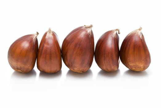 Some fresh chestnuts isolated over a white background.