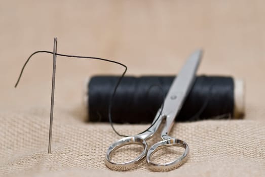 Traditional sewing items on a burlap surface.