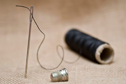 Traditional sewing items on a burlap surface.