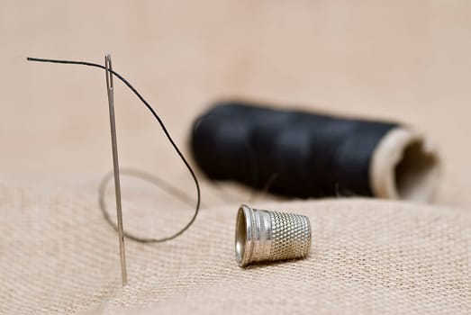 Traditional sewing items on a burlap surface.