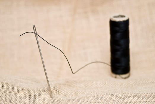 Traditional sewing items on a burlap surface.