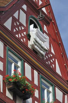 duvet exposed at a window of old wattle house in city center
