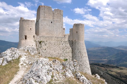 ruins of ancient fortification in barren landscape of apennine high mountains