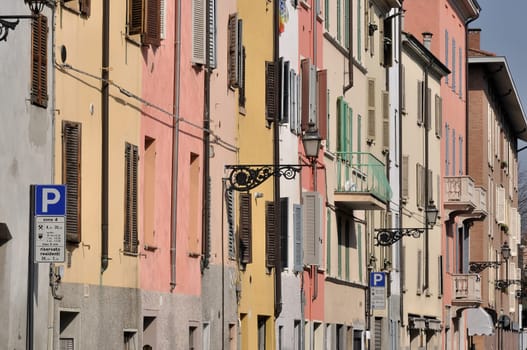 foreshortening of windows of ancient residential buildings aligned on the street in parma citycenter