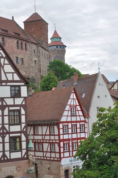view of old wattle houses in city center with the ancient castle on background