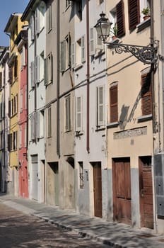 foreshortening of ancient residential buildings aligned on the street in parma citycenter