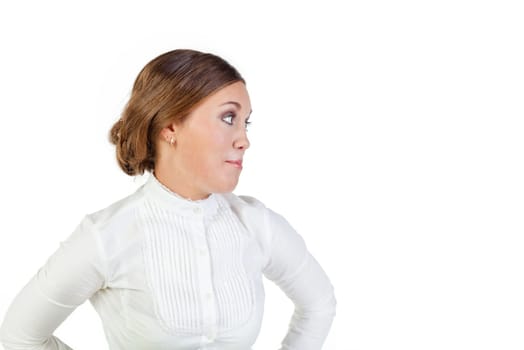 Pretty young businesswoman staying akimbo with an unhappy expression