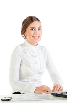 Smiling young businesswoman sitting at her workplace