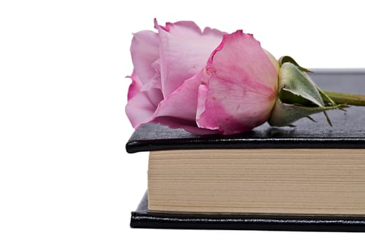 Old books and a pair of glasses isolated over a white background.