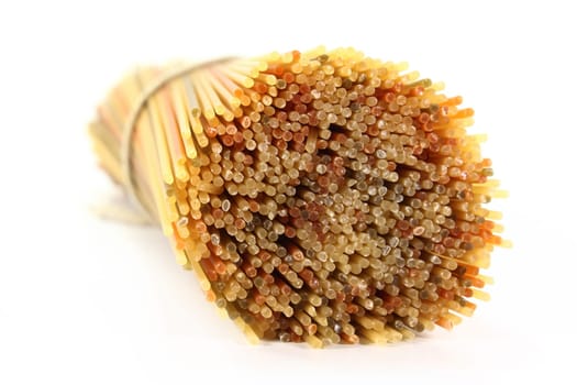 Uncooked spaghetti against white background
