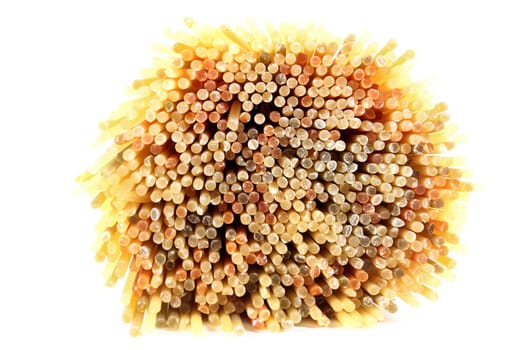 Uncooked spaghetti against white background
