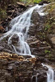 a beautiful waterfall on a mountain slope