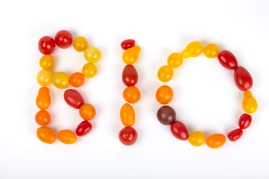 The BIO lettering is made up of small colorful organic tomatoes. The word "organic"" set of colorful small organic tomatoes."