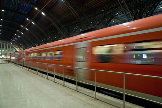 Fast train departing from the station motion blur