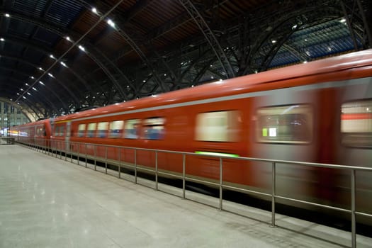 Fast train departing from the station motion blur
