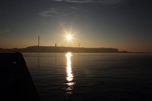 Silhouette of Heligoland in the backlight of the setting sun,taken from the neighboring island of Düne.