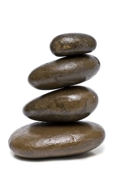 Boulders in zen balance over a white background.