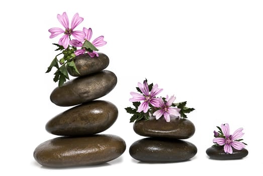 Boulders in zen balance over a white background.