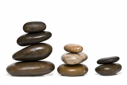 Boulders in zen balance over a white background.