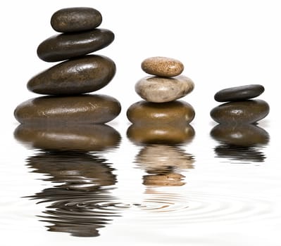 Boulders in zen balance over a white background.
