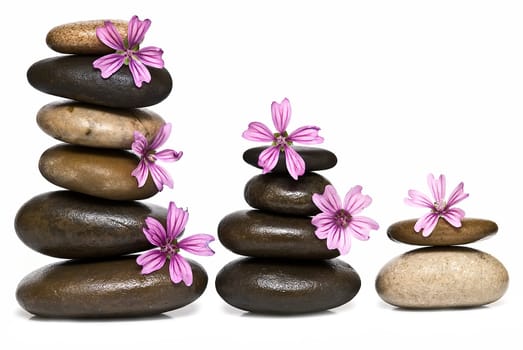 Boulders in zen balance over a white background.