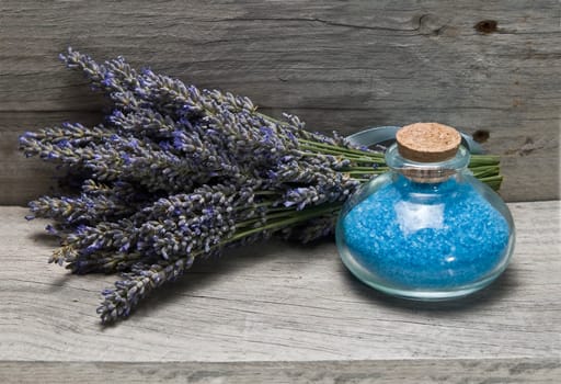 Lavender and some hygiene items made of lavender on an old wooden shelf.